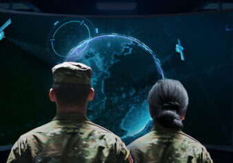 man and woman looking at control center screen working on national security solutions